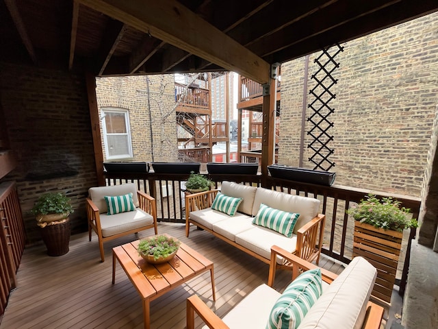 wooden terrace with an outdoor living space