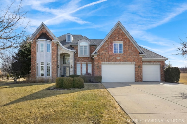 view of front facade featuring a garage, brick siding, concrete driveway, roof with shingles, and a front yard