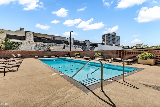 pool featuring a patio area and fence