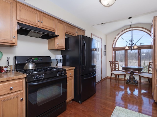 kitchen with dark wood-style flooring, light countertops, vaulted ceiling, under cabinet range hood, and black appliances