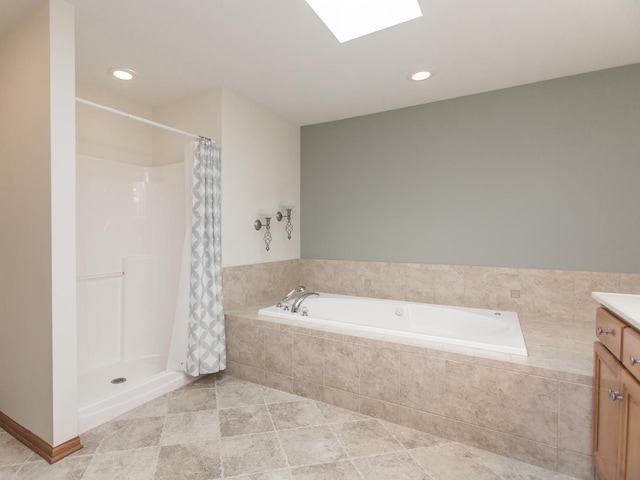 full bath with a skylight, a shower with shower curtain, tile patterned flooring, vanity, and a bath