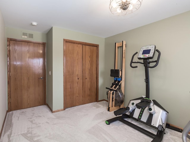 workout room featuring baseboards, visible vents, and light colored carpet