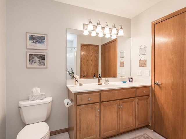 bathroom with a shower, baseboards, vanity, and toilet