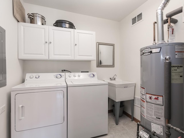 clothes washing area with cabinet space, baseboards, visible vents, washing machine and clothes dryer, and gas water heater