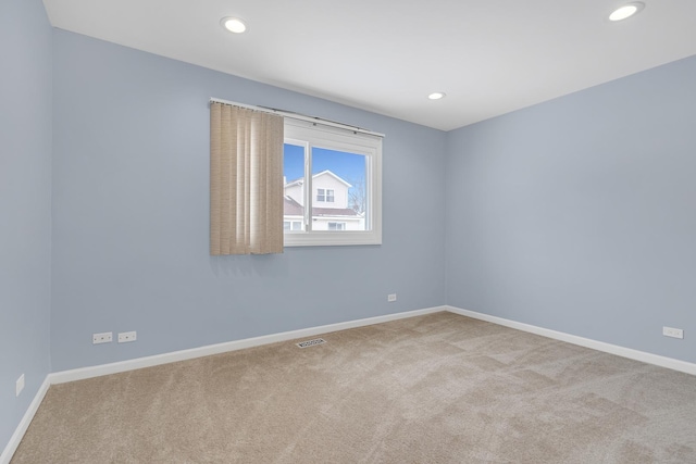 carpeted spare room featuring recessed lighting and baseboards