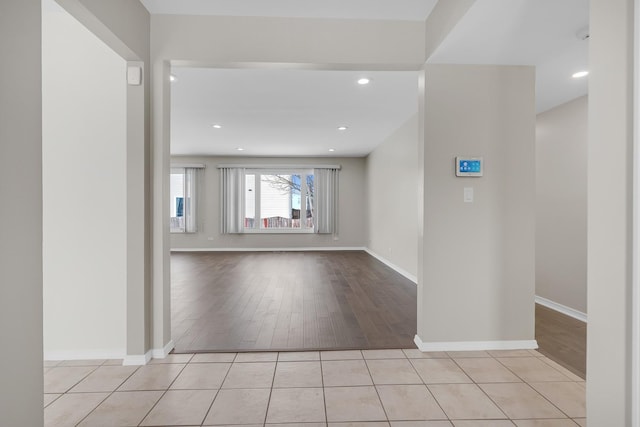 interior space with light tile patterned floors, baseboards, and recessed lighting