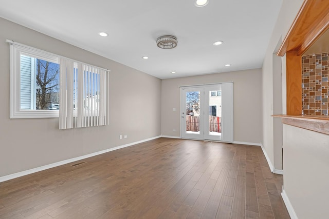 unfurnished room featuring recessed lighting, visible vents, dark wood finished floors, and baseboards