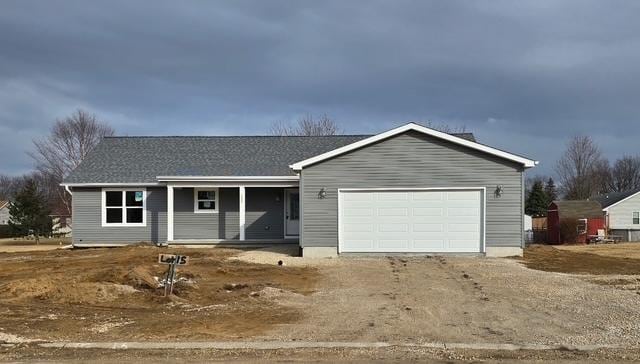 ranch-style house with a garage and driveway