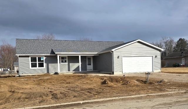 ranch-style home with a garage and dirt driveway