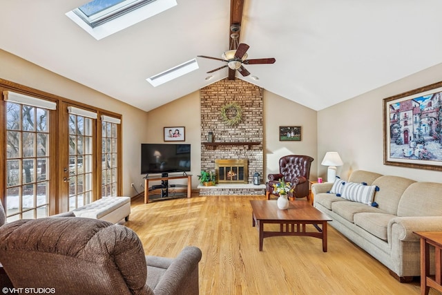 7821 Teton Rd, Orland Park, IL 60462 - living room with a skylight, lofted ceiling, a ceiling fan, light wood-style floors, and a fireplace