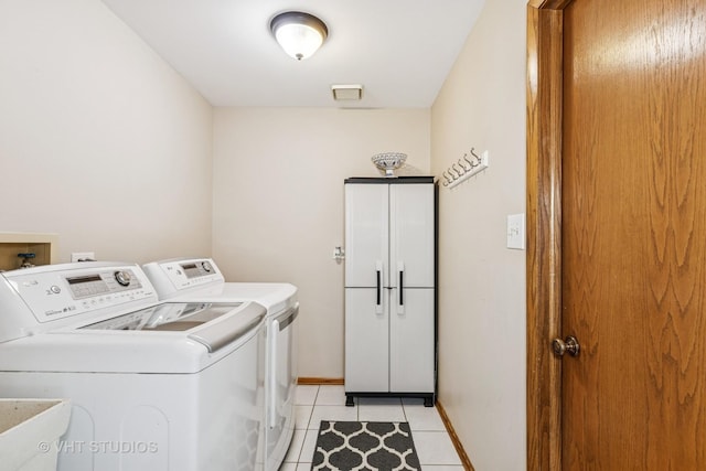 7821 Teton Rd, Orland Park, IL 60462 - laundry area featuring independent washer and dryer, light tile patterned floors, and cabinet space