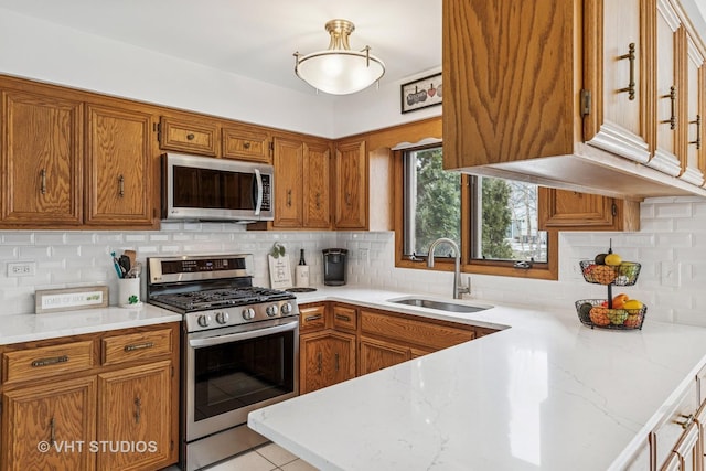 7821 Teton Rd, Orland Park, IL 60462 - kitchen with appliances with stainless steel finishes, brown cabinets, and backsplash