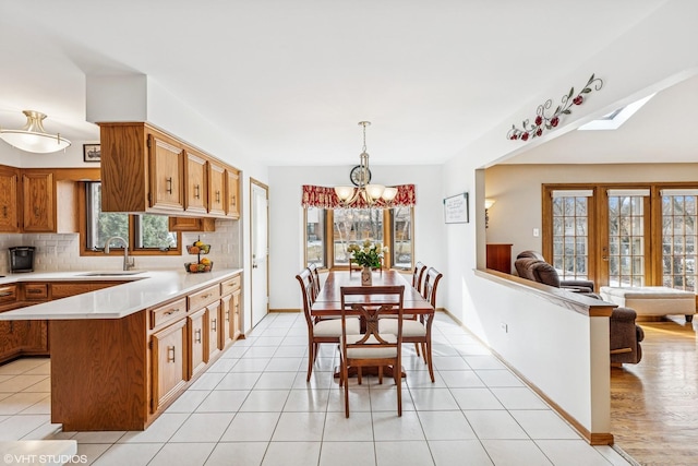 7821 Teton Rd, Orland Park, IL 60462 - kitchen featuring a chandelier, light countertops, plenty of natural light, and tasteful backsplash
