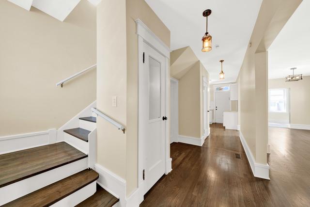 interior space with baseboards and wood finished floors