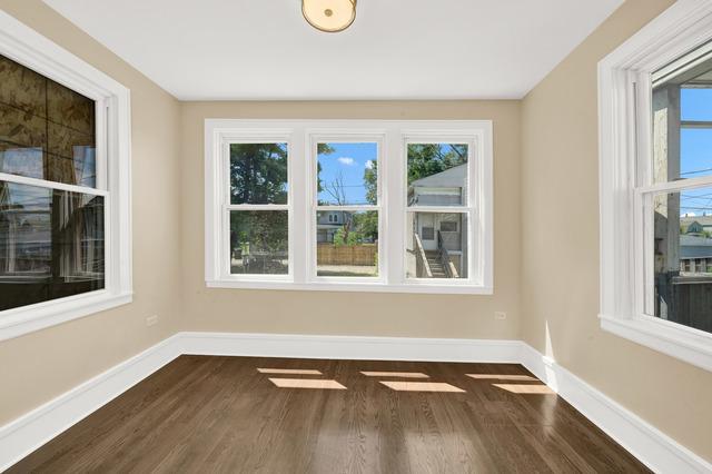 empty room featuring baseboards and dark wood-type flooring