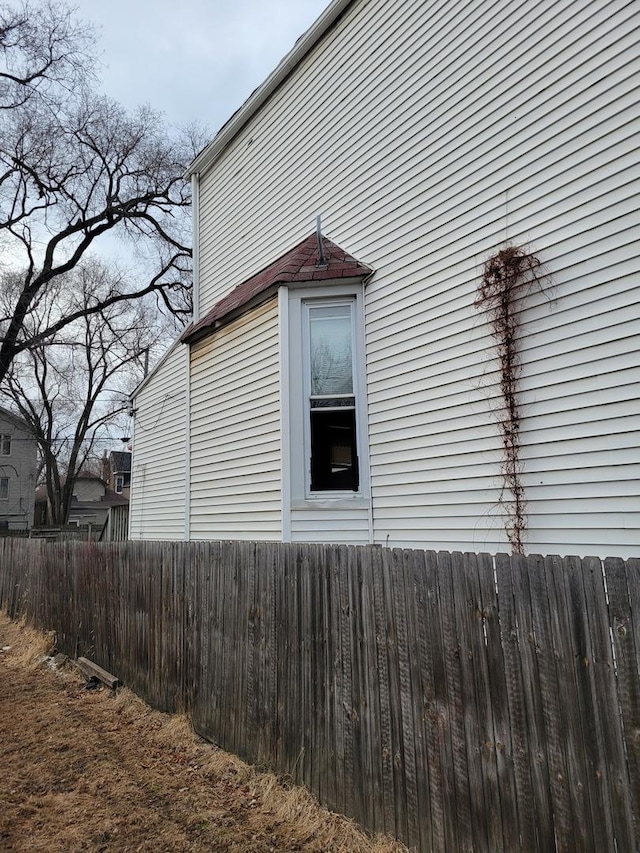 view of side of home with fence