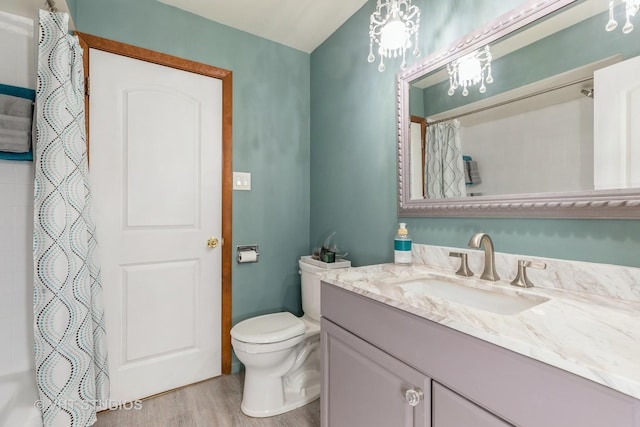 bathroom with a shower with shower curtain, vanity, toilet, and wood finished floors