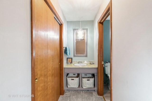 hall featuring carpet floors and a sink