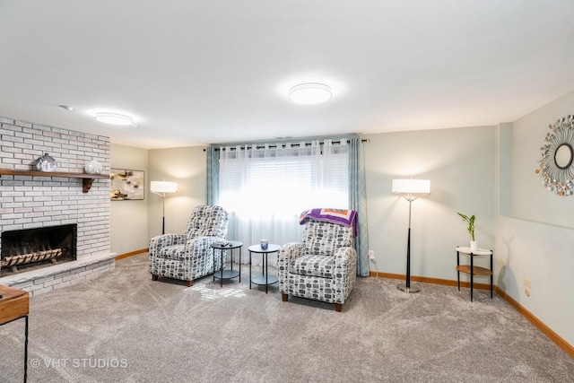 living area with carpet floors, a brick fireplace, and baseboards