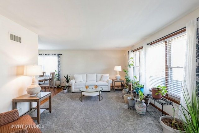 living room featuring visible vents and carpet flooring