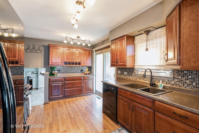 kitchen featuring light wood finished floors, tasteful backsplash, dishwasher, brown cabinets, and a sink