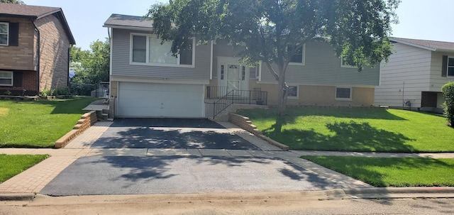 split foyer home with aphalt driveway, an attached garage, a front yard, and central AC