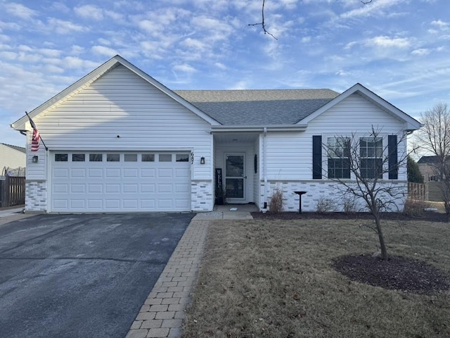 single story home with driveway, a garage, and roof with shingles