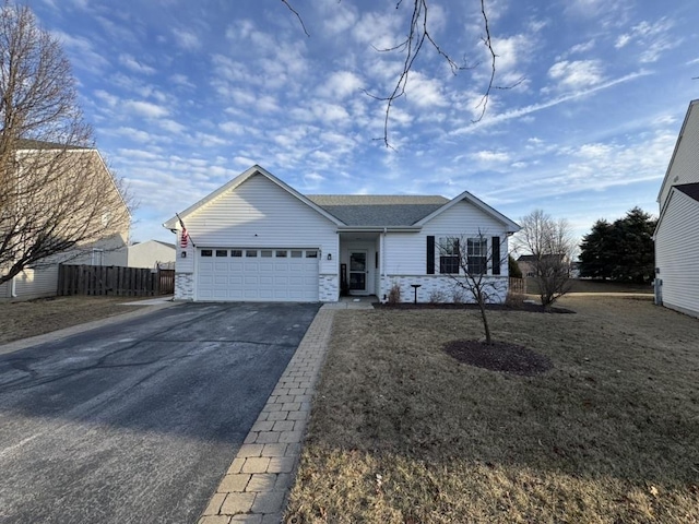 ranch-style home featuring an attached garage, fence, driveway, stone siding, and a front yard