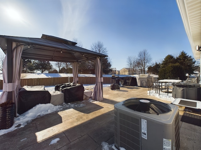 view of patio / terrace featuring outdoor dining area, central AC, and a gazebo