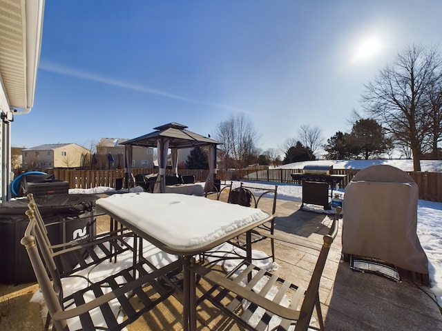 view of patio / terrace with a gazebo, outdoor dining space, and a fenced backyard