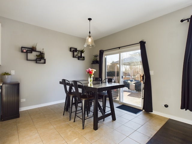 dining room with light tile patterned floors and baseboards