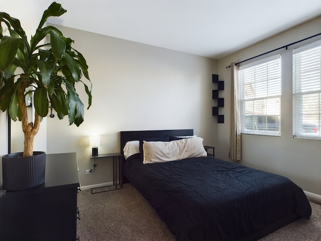 carpeted bedroom featuring baseboards