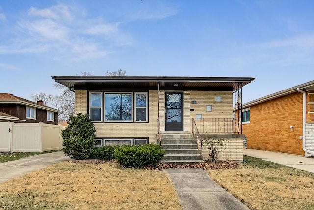 view of front of house featuring brick siding and fence