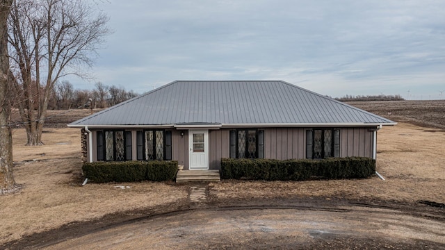 view of front of house with metal roof and board and batten siding