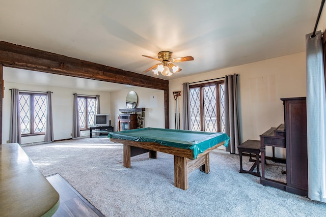 playroom with a ceiling fan, pool table, beam ceiling, and light colored carpet