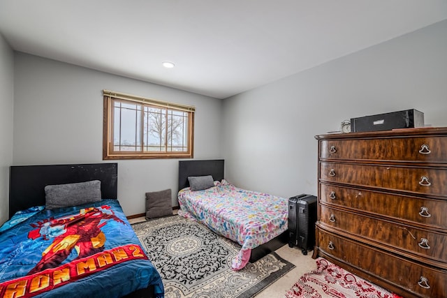 bedroom with light carpet and baseboards