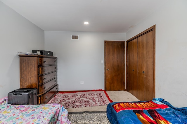 carpeted bedroom with recessed lighting, a closet, visible vents, and baseboards