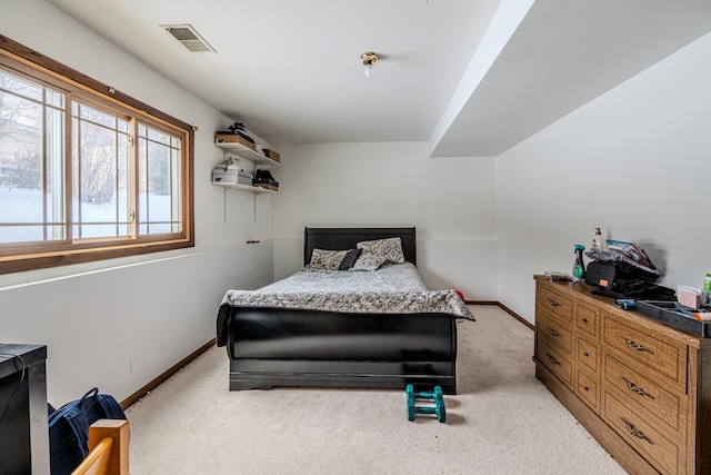 bedroom featuring baseboards, visible vents, and light colored carpet