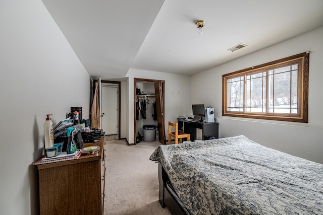 bedroom with light carpet, a closet, and visible vents