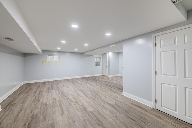 basement with light wood-style floors, baseboards, visible vents, and recessed lighting