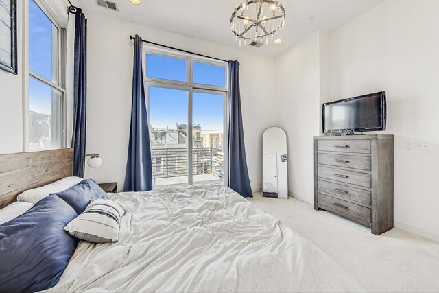 carpeted bedroom with visible vents, baseboards, and an inviting chandelier