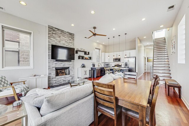 dining area featuring recessed lighting, visible vents, wood finished floors, and a fireplace