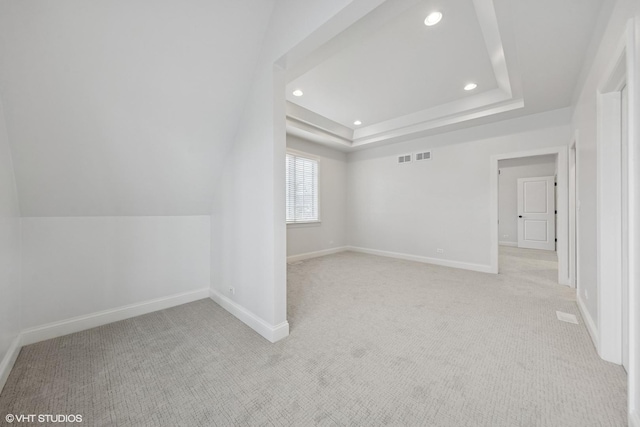 additional living space with light carpet, baseboards, and recessed lighting