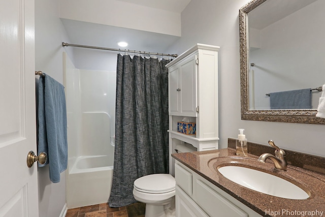 bathroom featuring stone finish flooring, vanity, toilet, and shower / bath combo with shower curtain