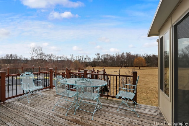 wooden deck featuring outdoor dining area