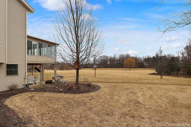 view of yard featuring a patio area and a sunroom