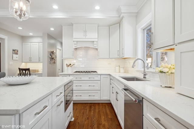 kitchen with dark wood finished floors, a sink, white cabinetry, stainless steel dishwasher, and recessed lighting