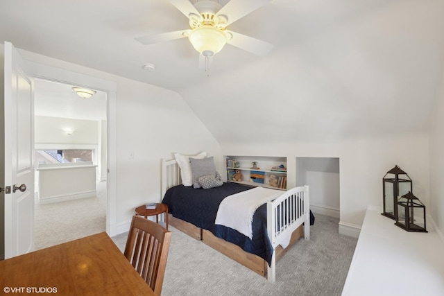 bedroom with vaulted ceiling, ceiling fan, carpet flooring, and baseboards