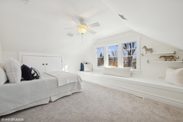 carpeted bedroom featuring vaulted ceiling, visible vents, and ceiling fan