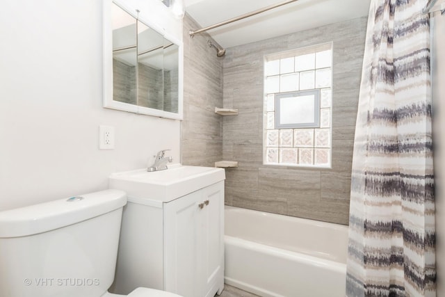 bathroom with toilet, shower / tub combo with curtain, and vanity